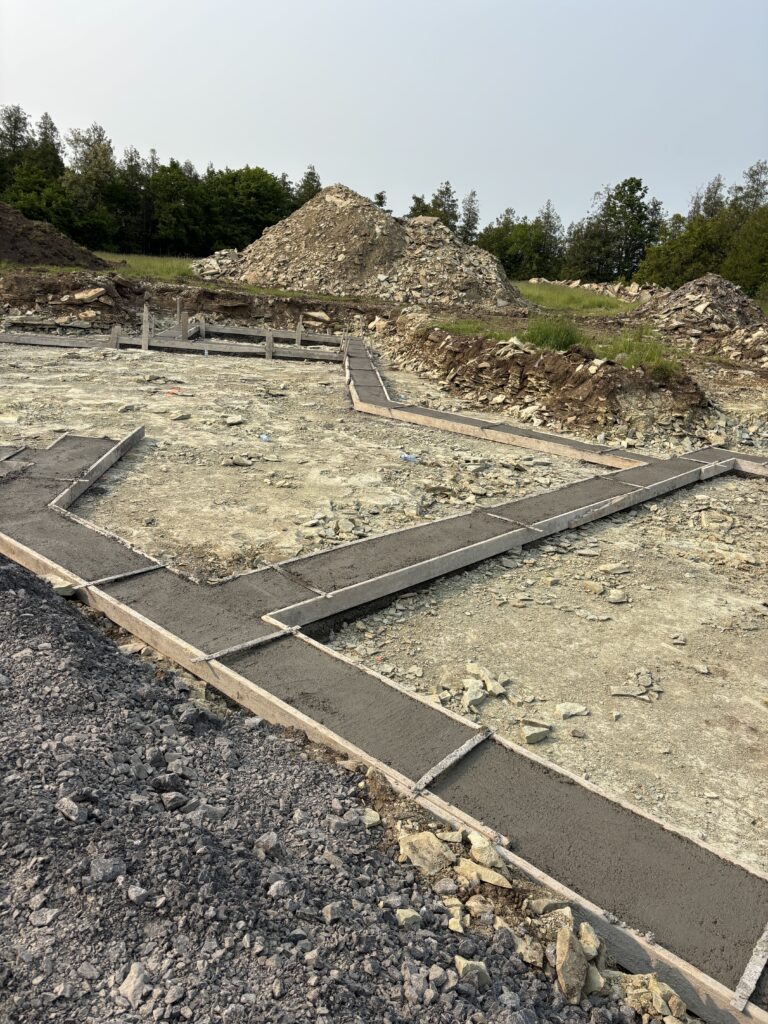 Close-up of slab footings in place, showing layout of foundation trench work before slab pour.