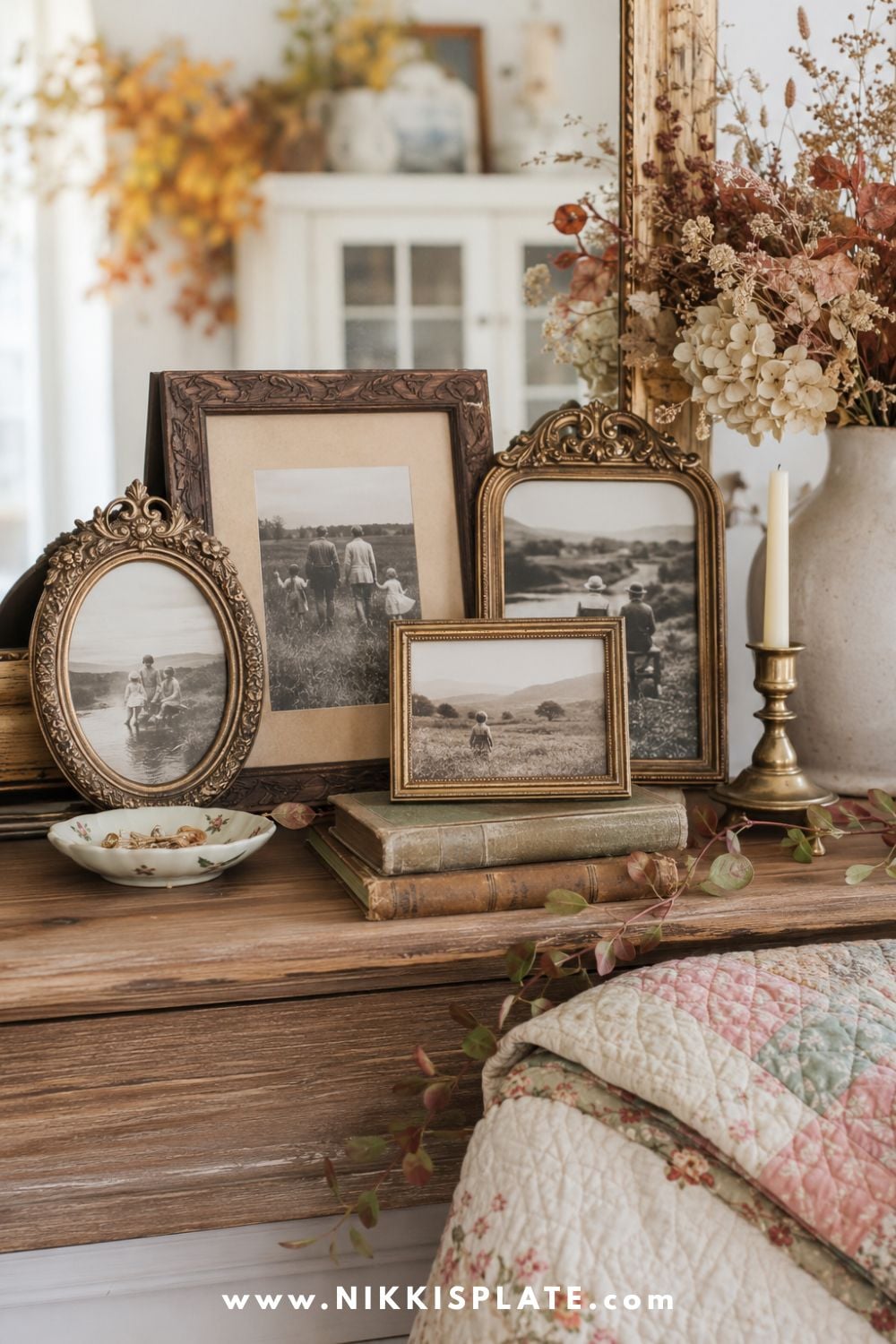 Vintage family photographs in mismatched brass and wood frames styled with dried flowers, books and autumn accents.