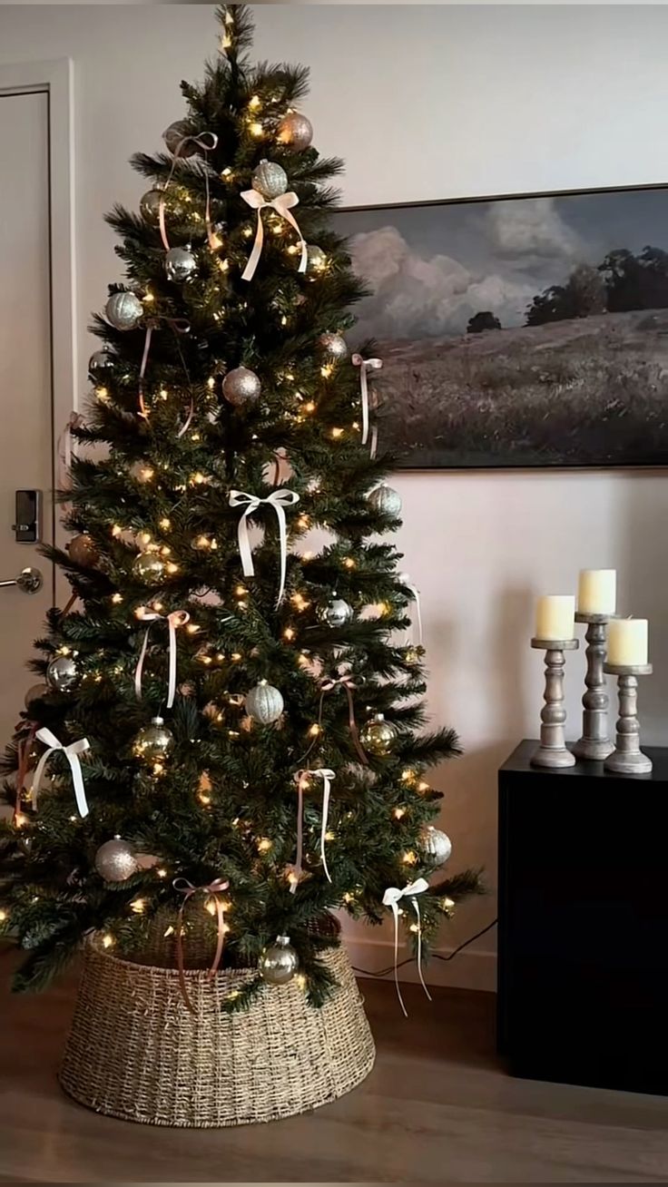 Christmas tree with a seagrass woven tree collar, metallic ornaments, and ribbon bows for a natural rustic holiday decor look.