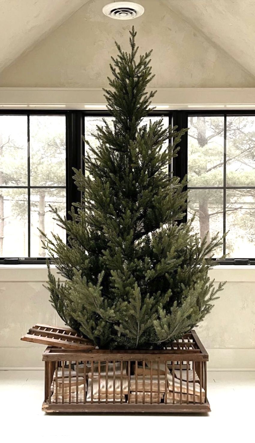 DIY wooden crate Christmas tree collar with slatted sides and built-in storage for a unique farmhouse holiday decor idea.