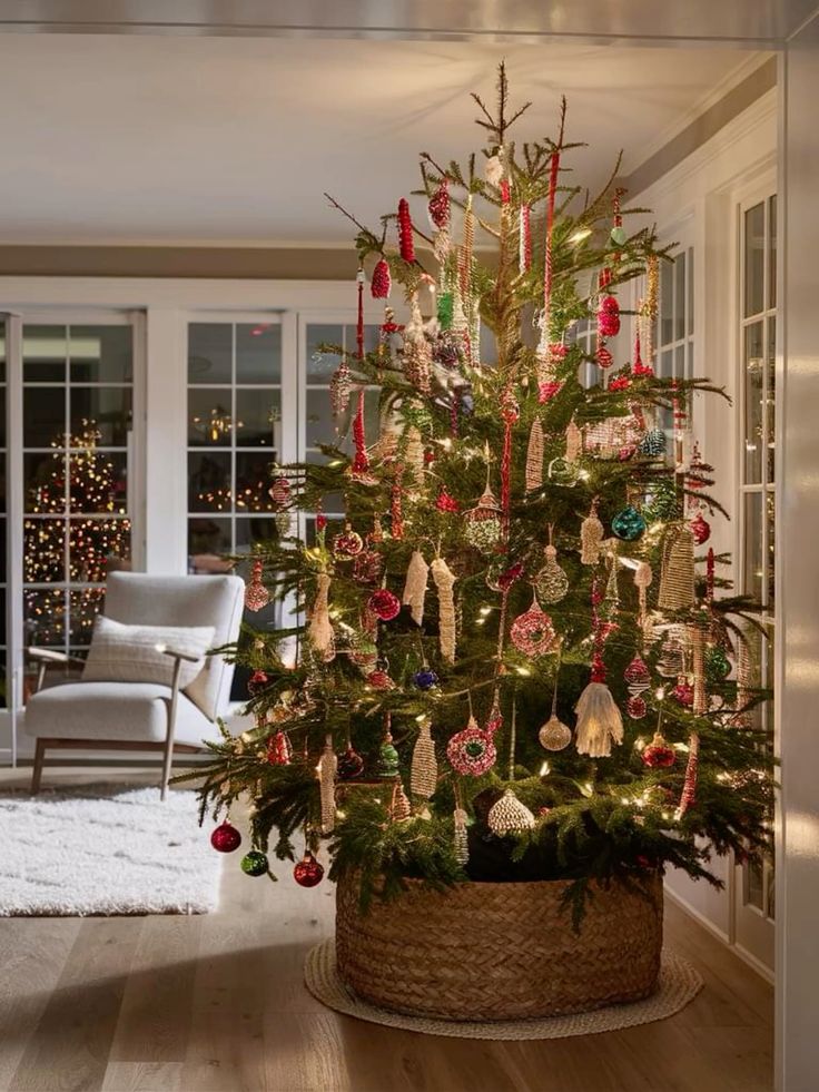 Christmas tree with a braided basket tree collar, colorful ornaments, and warm holiday lights in a cozy farmhouse style living room.