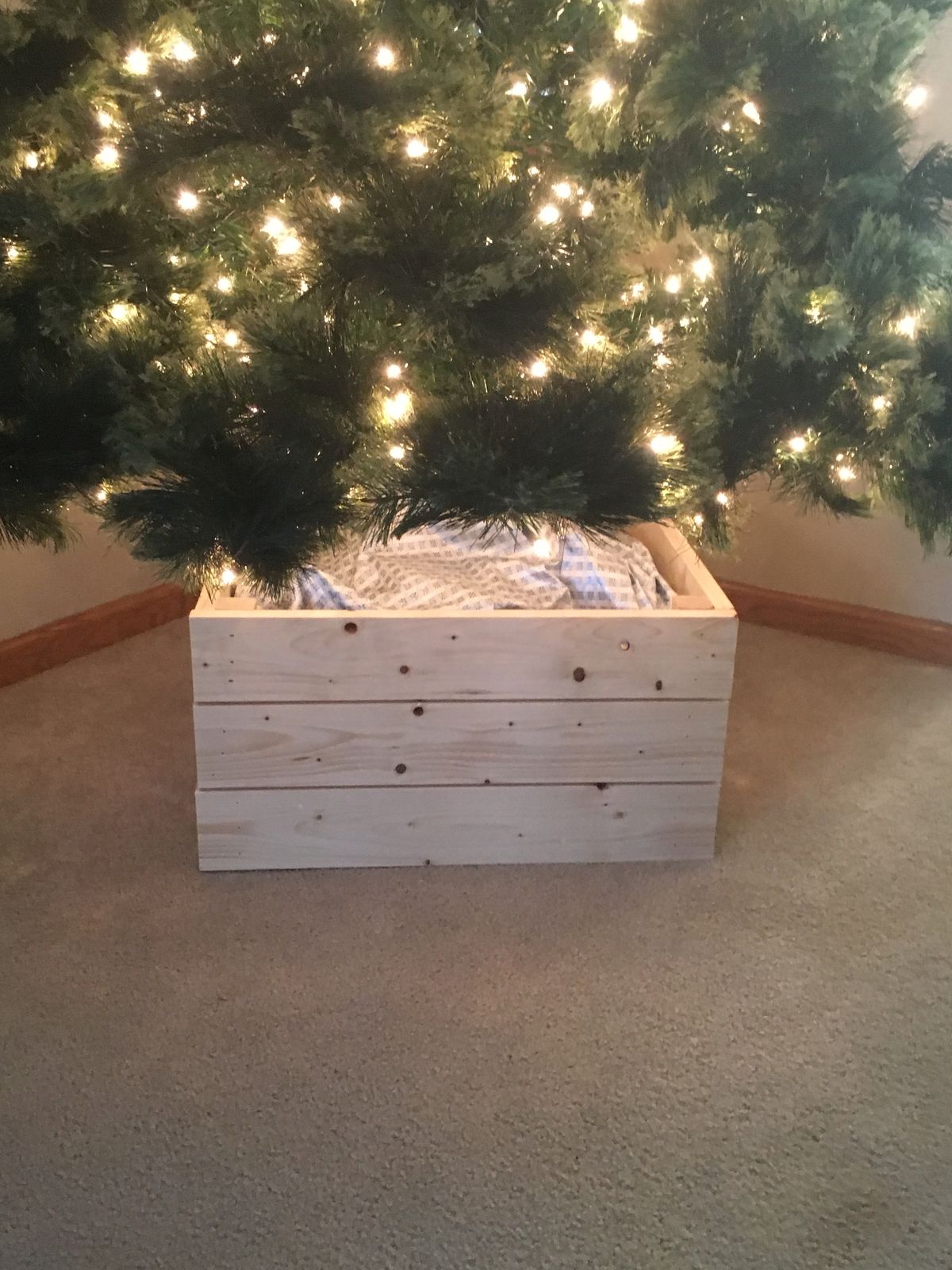 DIY wooden box Christmas tree collar made from simple lumber for a budget-friendly farmhouse holiday decor idea.