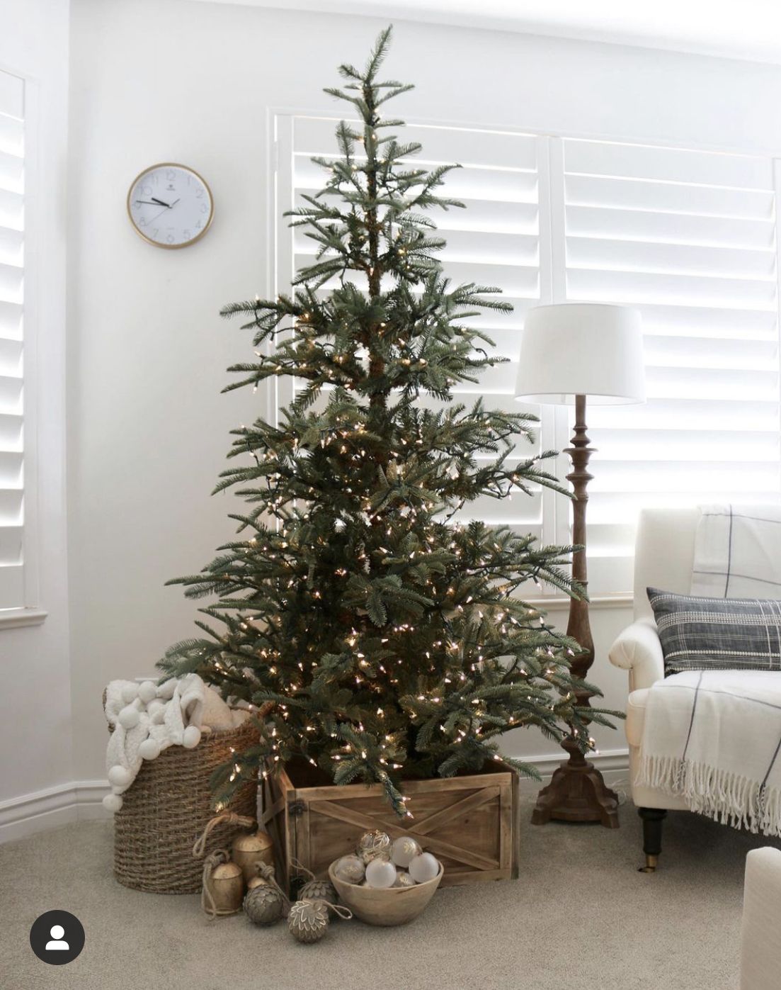 DIY rustic wooden crate Christmas tree collar with warm white lights and neutral holiday decor in a cozy farmhouse living room.