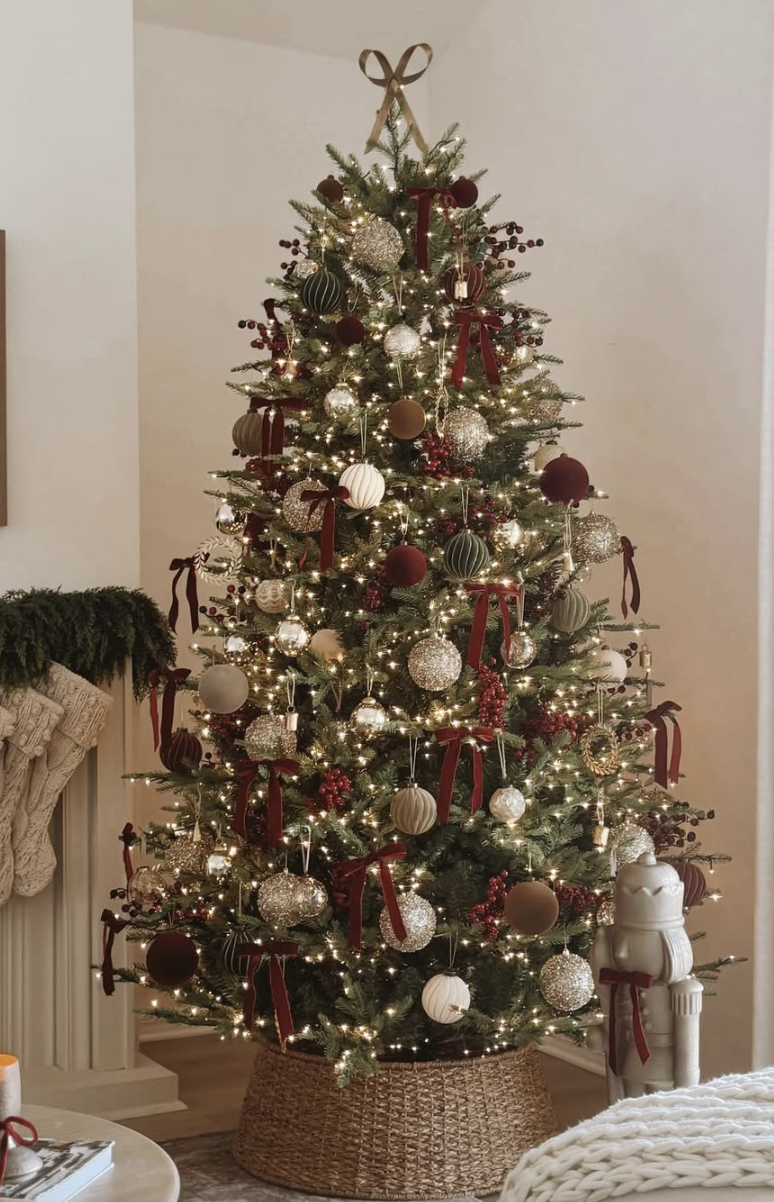 cozy farmhouse Christmas tree with gold and burgundy ornaments, wicker basket base, and warm white lights for rustic holiday decor