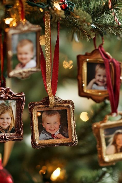 DIY mini framed photo ornaments with children's pictures in small gold and bronze frames hanging on a Christmas tree with red and gold ribbons