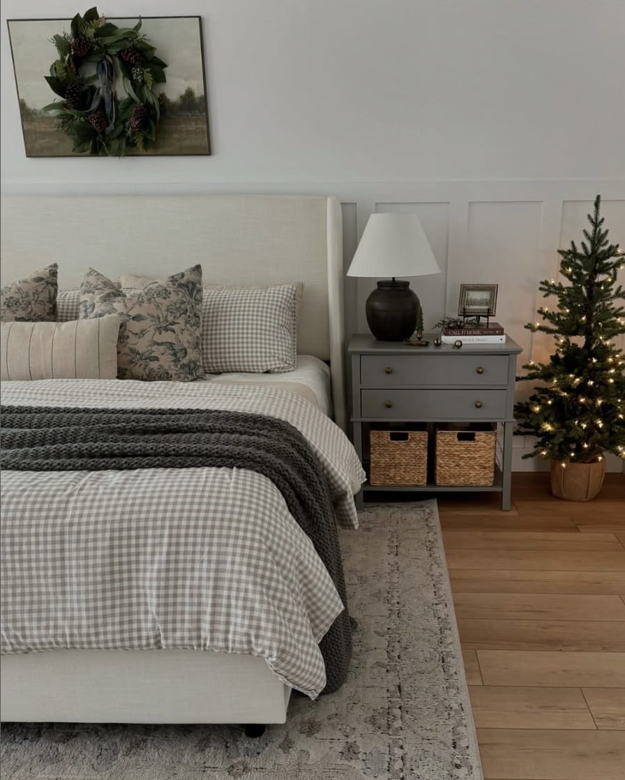 modern farmhouse christmas bedroom with neutral bedding, mini christmas tree, and cozy layered textures