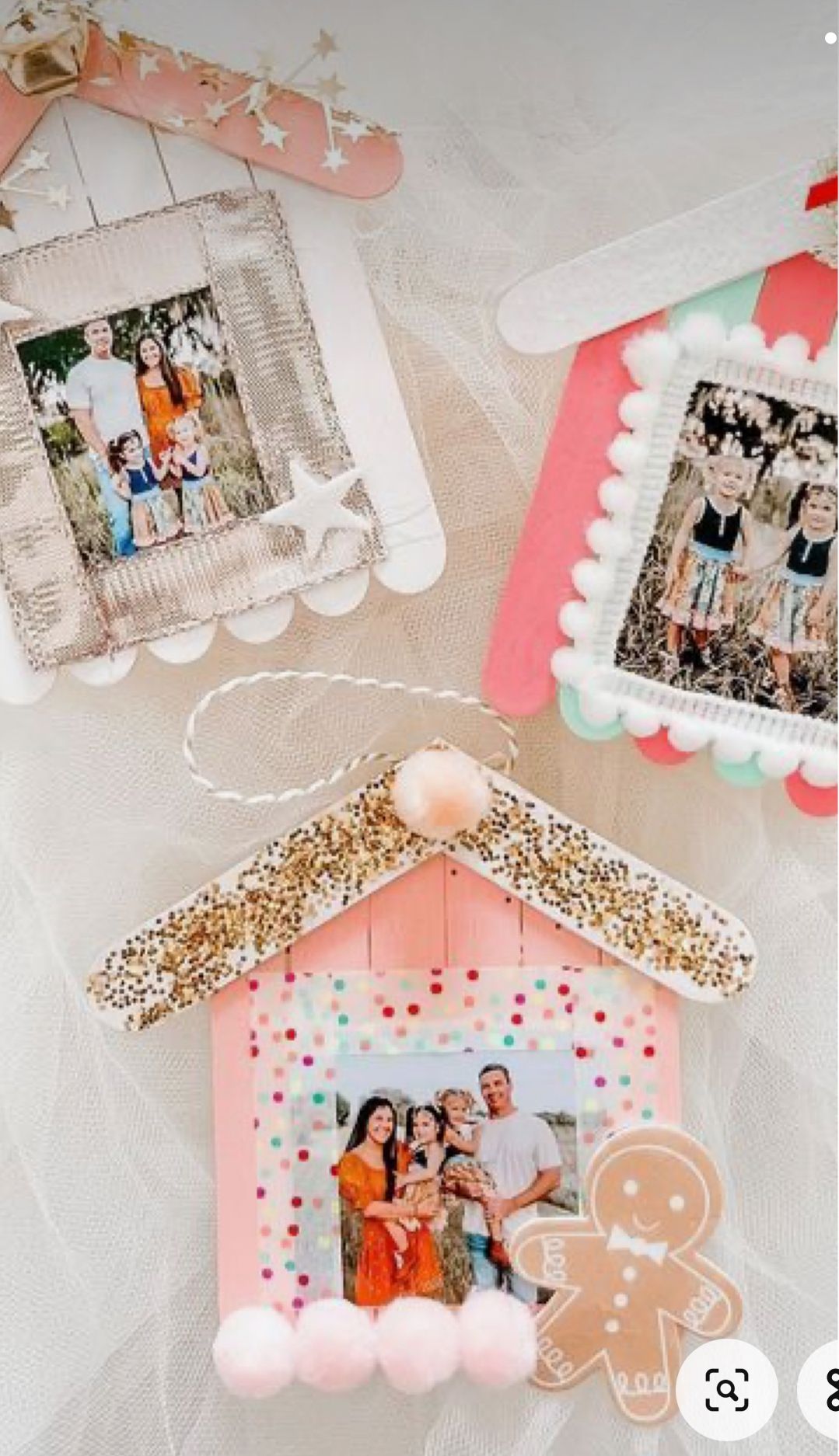 DIY popsicle stick gingerbread house photo ornaments decorated with glitter, pastel colors, pom-poms, and family photos