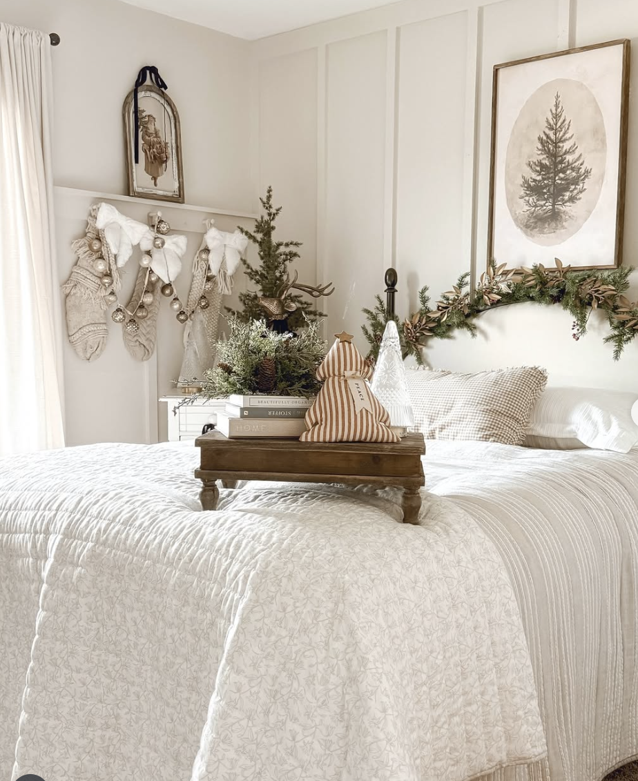 rustic farmhouse christmas bedroom with garland, knit stockings, and cozy neutral bedding
