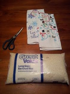 Supplies for making a DIY rice heat pack using holiday tea towels, rice, and scissors - an easy and cozy homemade homemaker gift idea for Christmas.