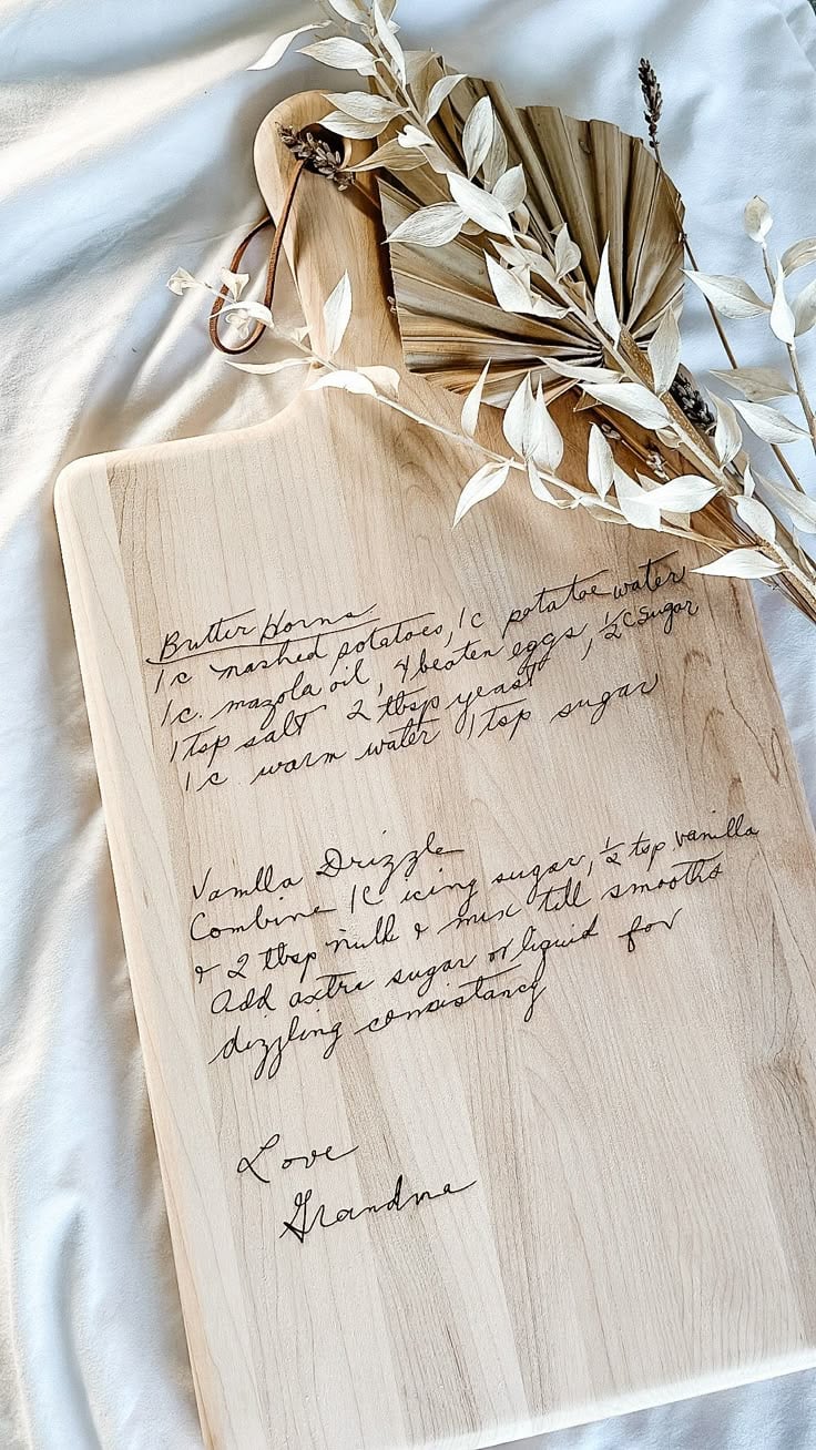 Engraved wooden cutting board featuring a handwritten family recipe - a sentimental and personalized homemade homemaker gift idea for Christmas.