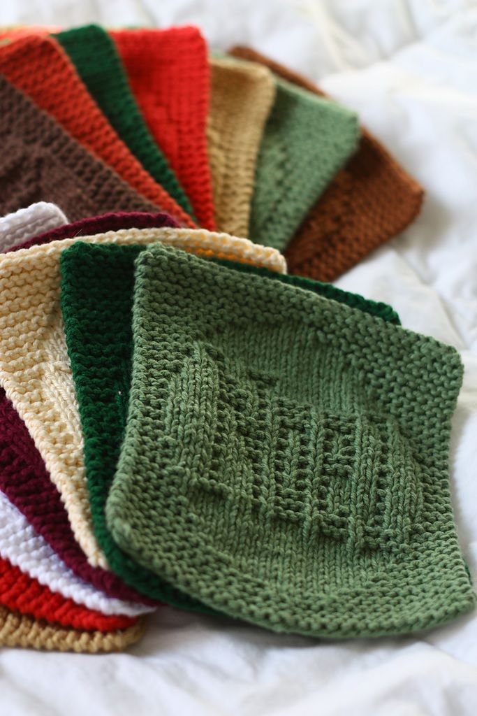 Stack of colorful hand-knitted dishcloths made from cotton yarn - a cozy and practical homemade homemaker gift idea for Christmas.