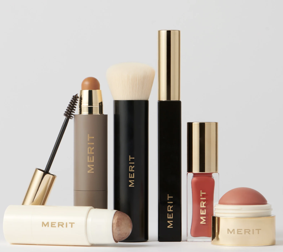 MERIT Five Minute Morning Kit clean beauty essentials including foundation stick, brush, mascara, blush, and tinted lip oil.