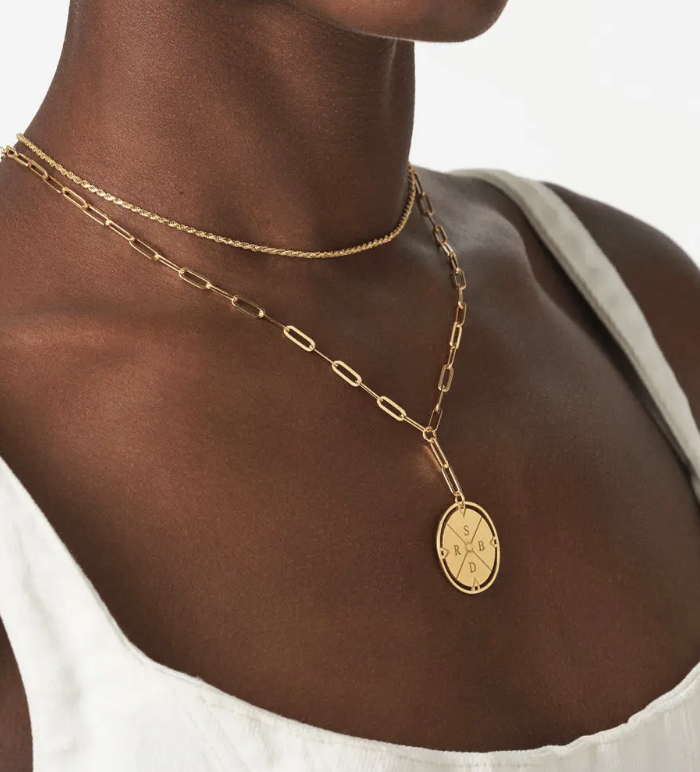 Gold Oak and Luna engraved compass necklace with personalized initials worn on a woman's neck.