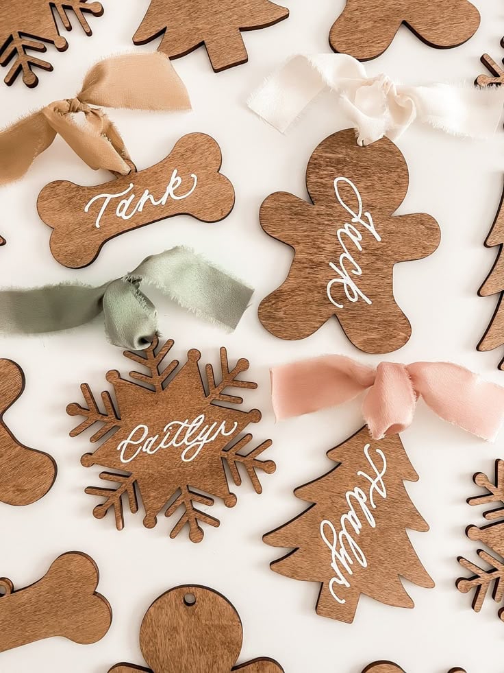 Personalized wooden Christmas ornaments with handwritten names and ribbon bows - a charming homemade homemaker gift idea for the holidays.
