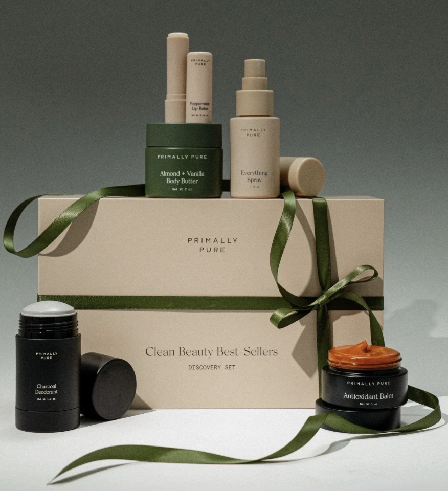 Primally Pure Clean Beauty Best-Sellers Discovery Set with natural skincare products and gift box tied in green ribbon.