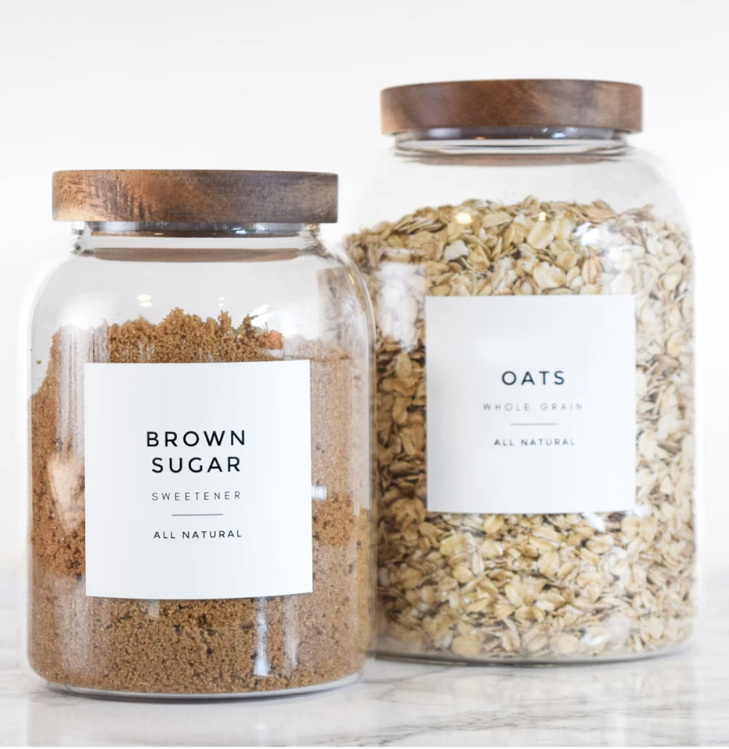 Glass pantry jars with minimalist printable labels for oats and brown sugar - a stylish and practical homemade homemaker gift idea for Christmas.