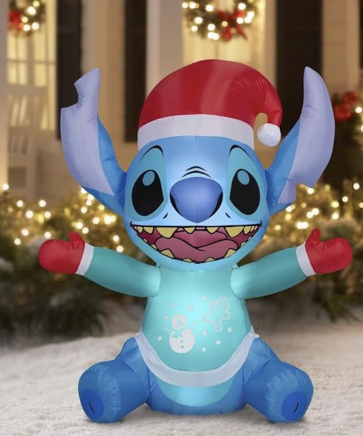 Large outdoor Christmas inflatable featuring Stitch wearing a Santa hat, gloves, and a winter sweater.