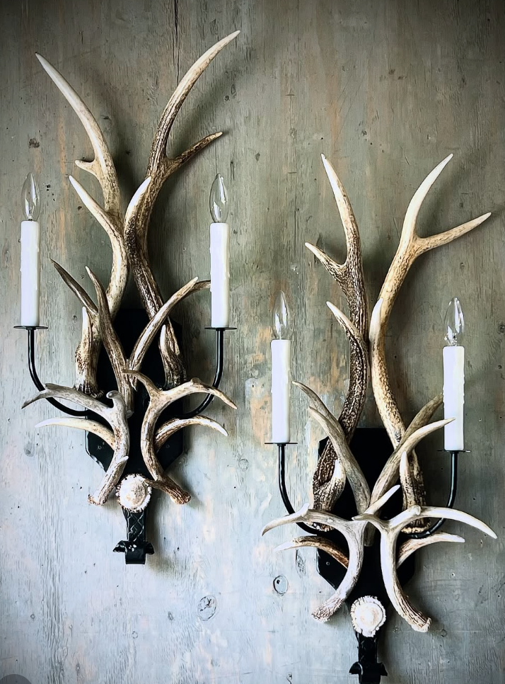 Antler wall sconce lighting with deer aesthetic charm featuring rustic antlers and warm candle-style bulbs