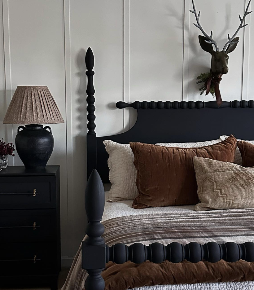 Cozy deer aesthetic bedroom decor with a dark wood bed, neutral bedding, and a subtle deer wall accent