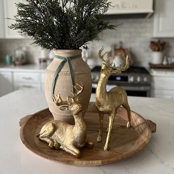 Gold deer aesthetic tabletop decor featuring small deer figurines styled on a wooden tray in a cozy cottage kitchen