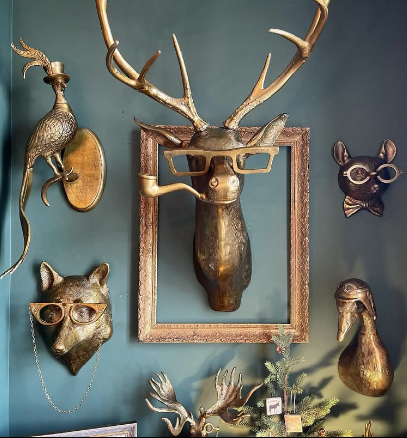 Eclectic vintage deer aesthetic wall decor featuring gold deer wall art, antique frames, and whimsical woodland accents