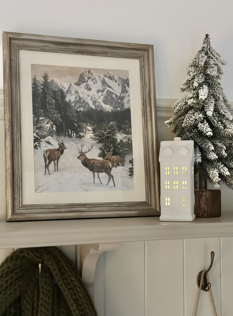 Winter deer aesthetic decor featuring framed deer artwork, snowy woodland scenery, and cozy neutral accents