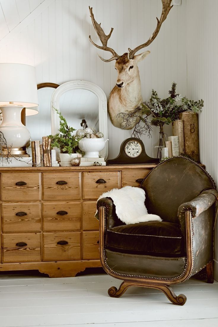 Winter deer aesthetic interior featuring a mounted deer accent, warm wood furniture, vintage decor, and soft neutral tones