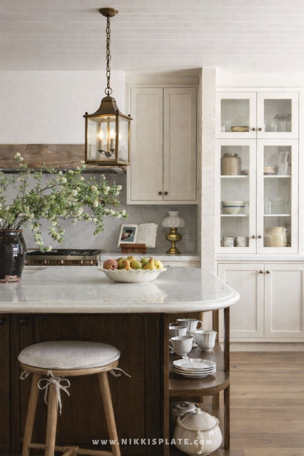 Vintage European lantern pendant light hanging above a marble kitchen island in a European farmhouse kitchen.