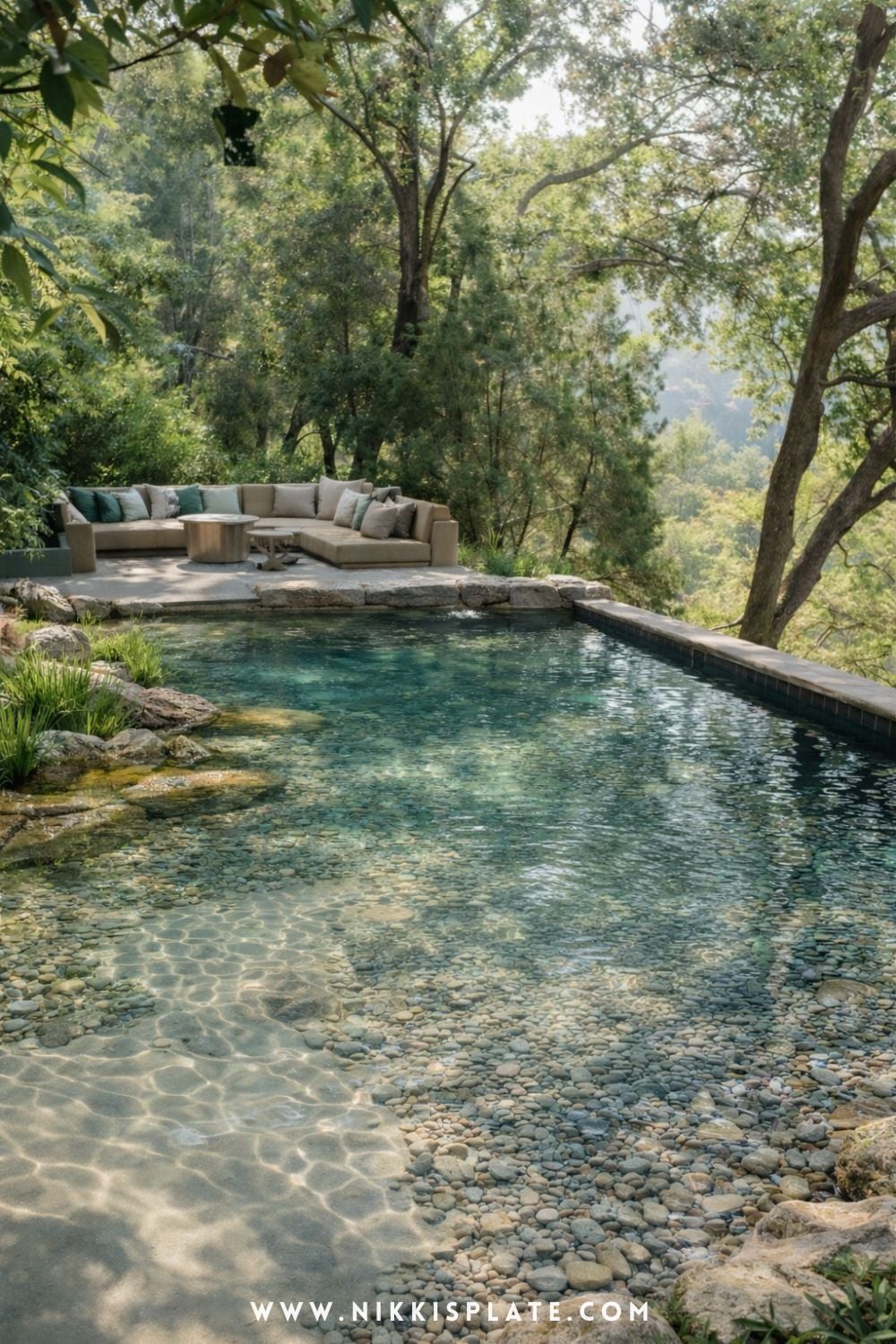 Natural swimming pool with shallow lounge area and submerged wooden loungers surrounded by lush greenery