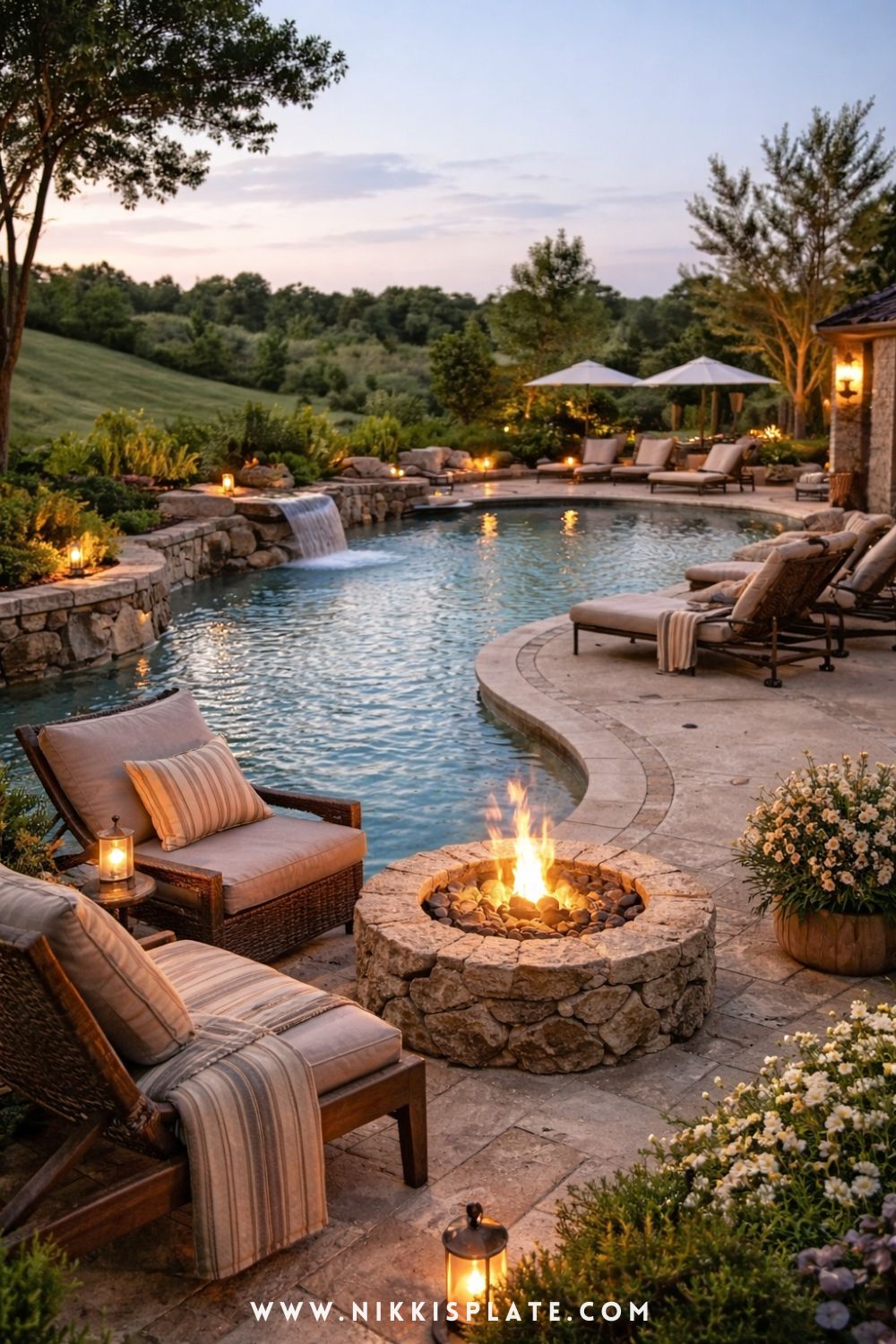 cozy backyard pool with lounge area, rustic fire pit, cushioned seating, and soft outdoor lighting at dusk
