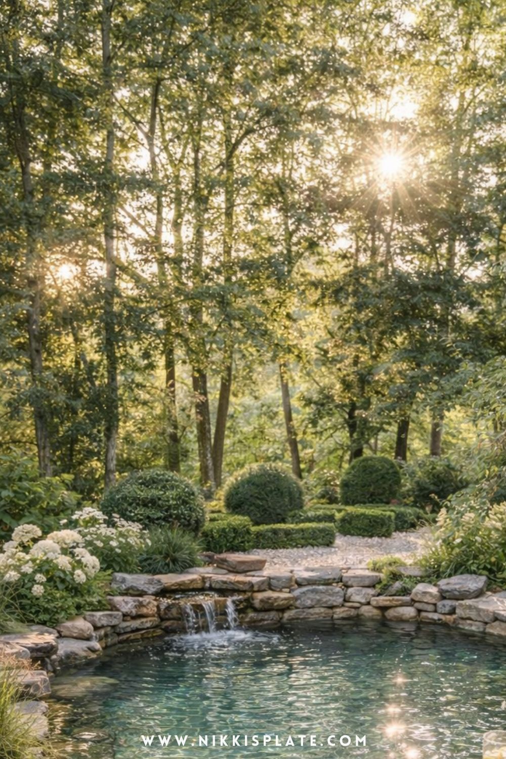 small natural swimming pool with stone edges, waterfall feature, and cozy backyard garden setting