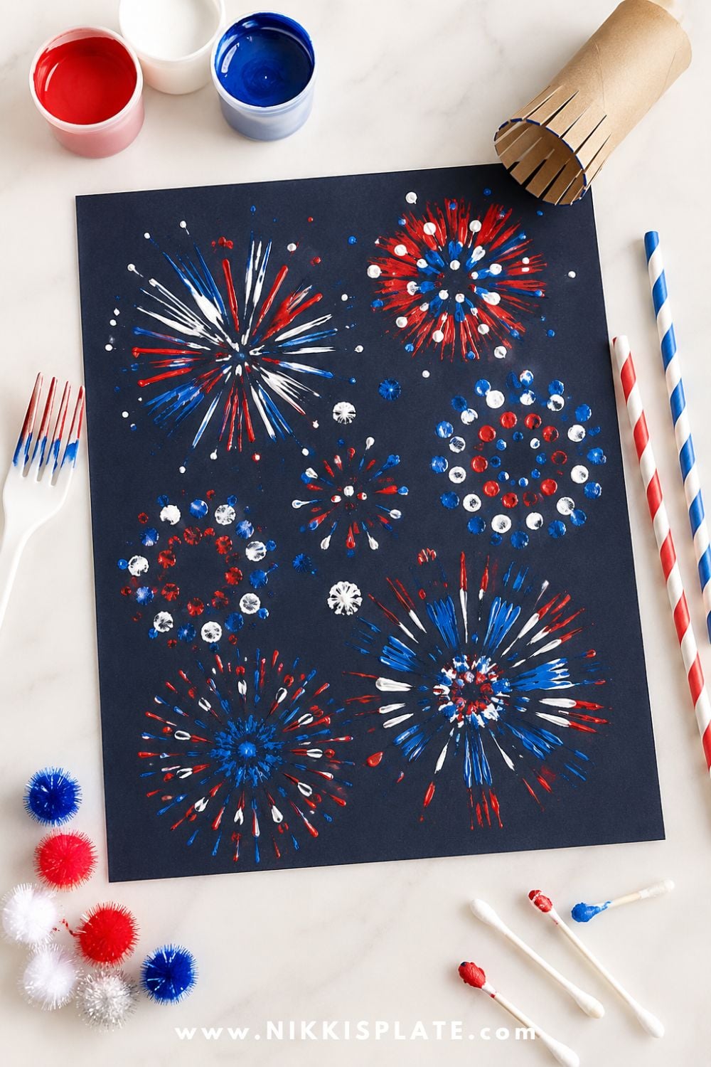 Firework painting craft for kids with red, white, and blue paint stamped onto navy cardstock using Q-tips, pom-poms, and paper rolls