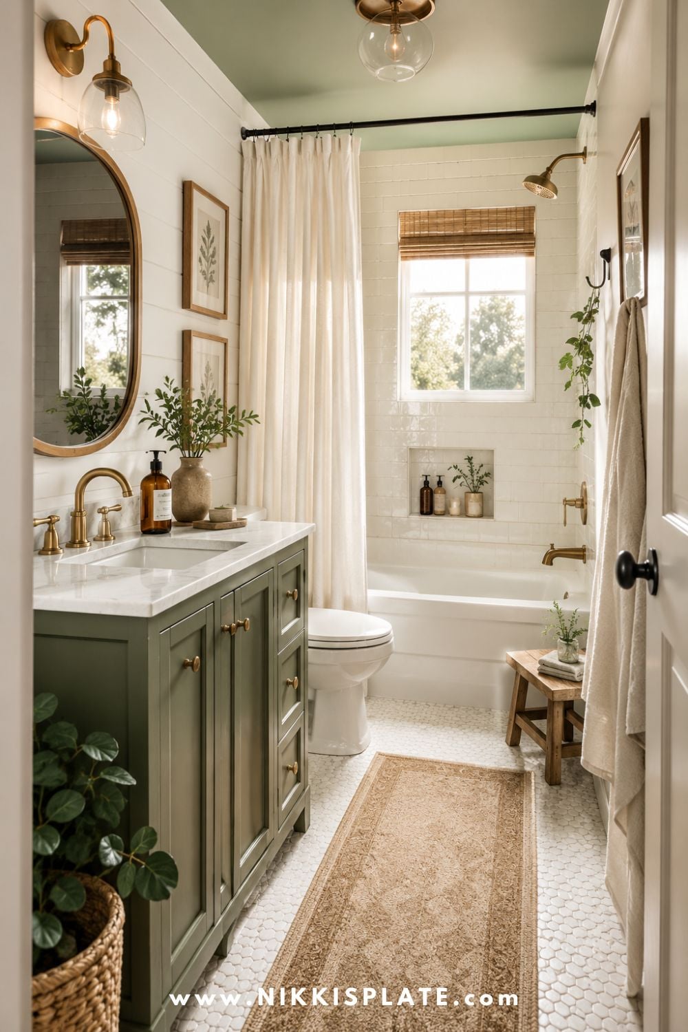Small green modern farmhouse bathroom with a sage green vanity, white shiplap walls, brass fixtures, warm wood accents, and a cozy vintage rug.