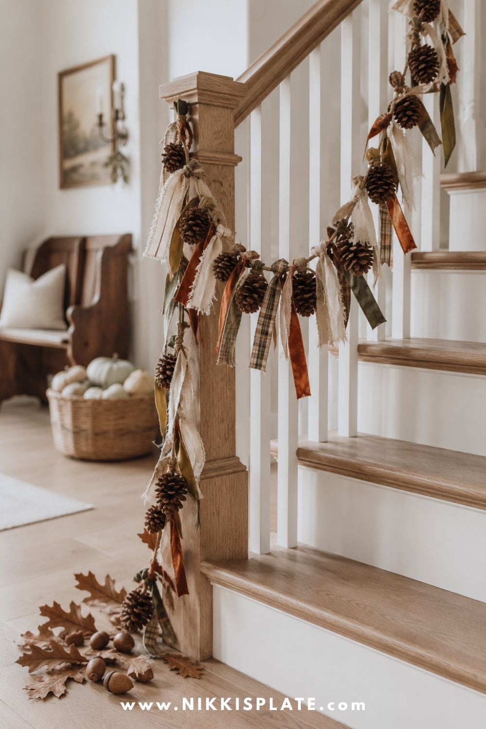 Natural pinecone garland accented with linen, velvet and plaid ribbon along a white oak farmhouse staircase.