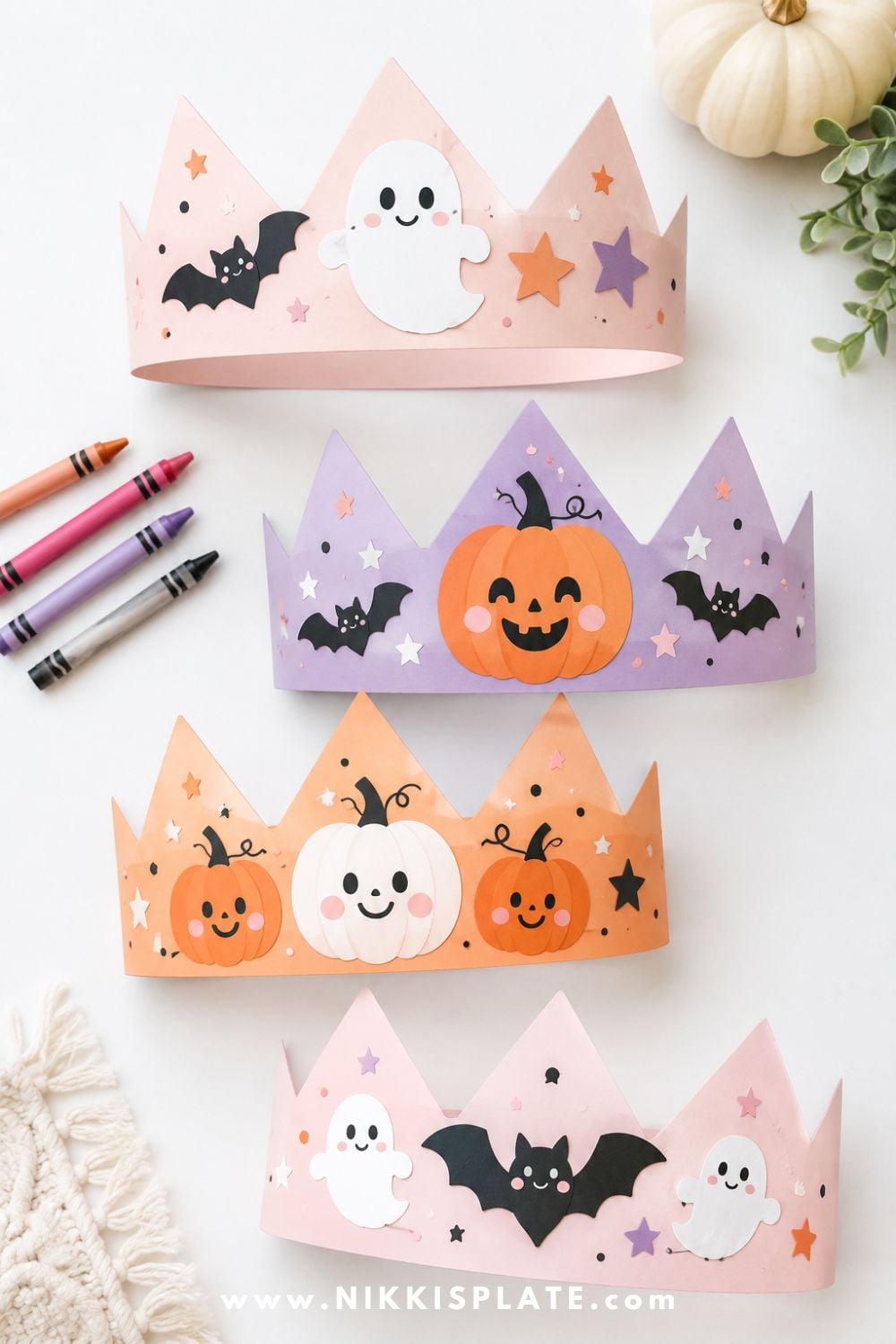 Paper Halloween coloring crowns decorated with pumpkins, ghosts, bats, and stars for a simple printable-style Halloween craft for kids.
