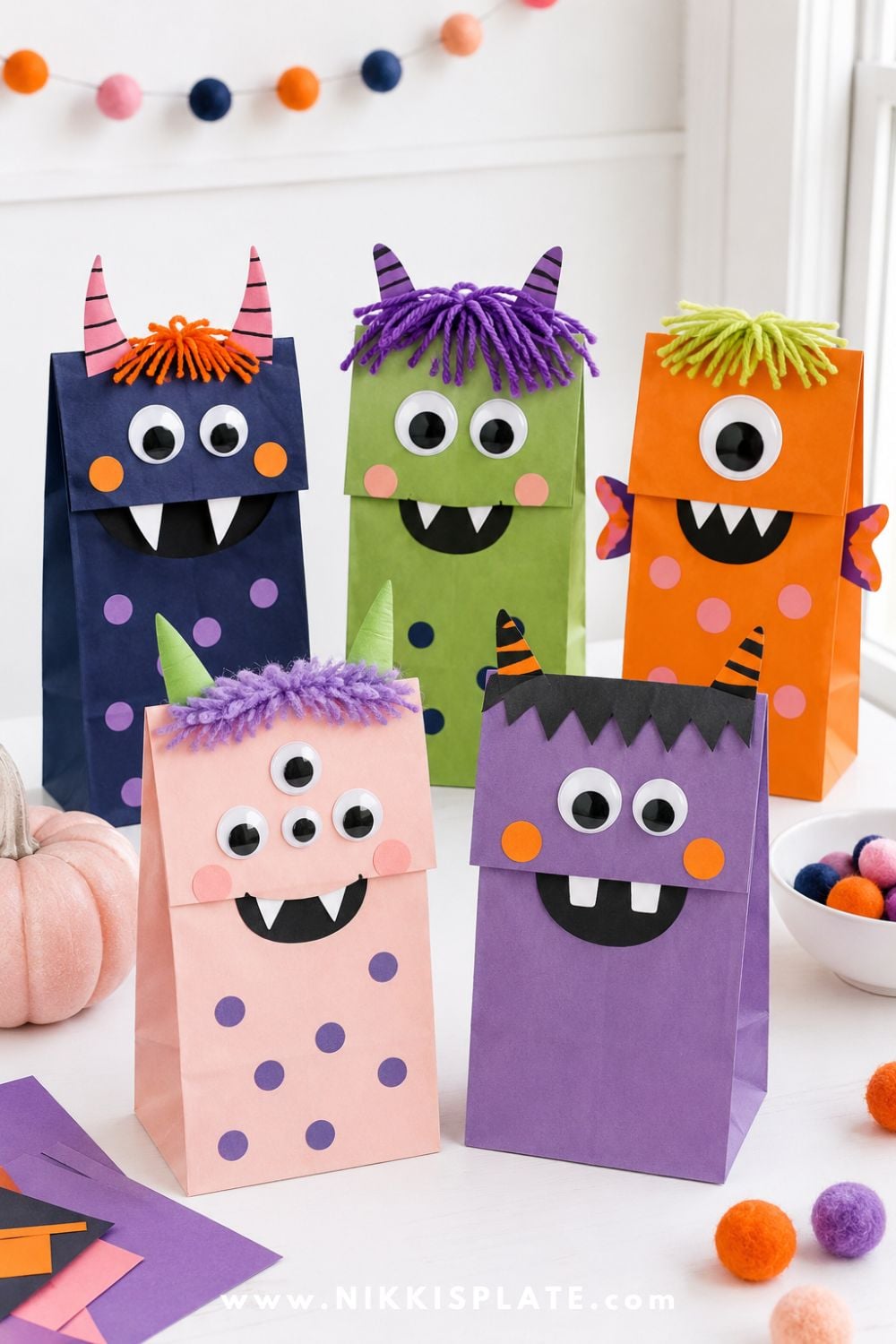 Colorful paper bag monster puppets with googly eyes, yarn hair, paper teeth, and silly faces for a fun Halloween craft for kids and preschoolers.