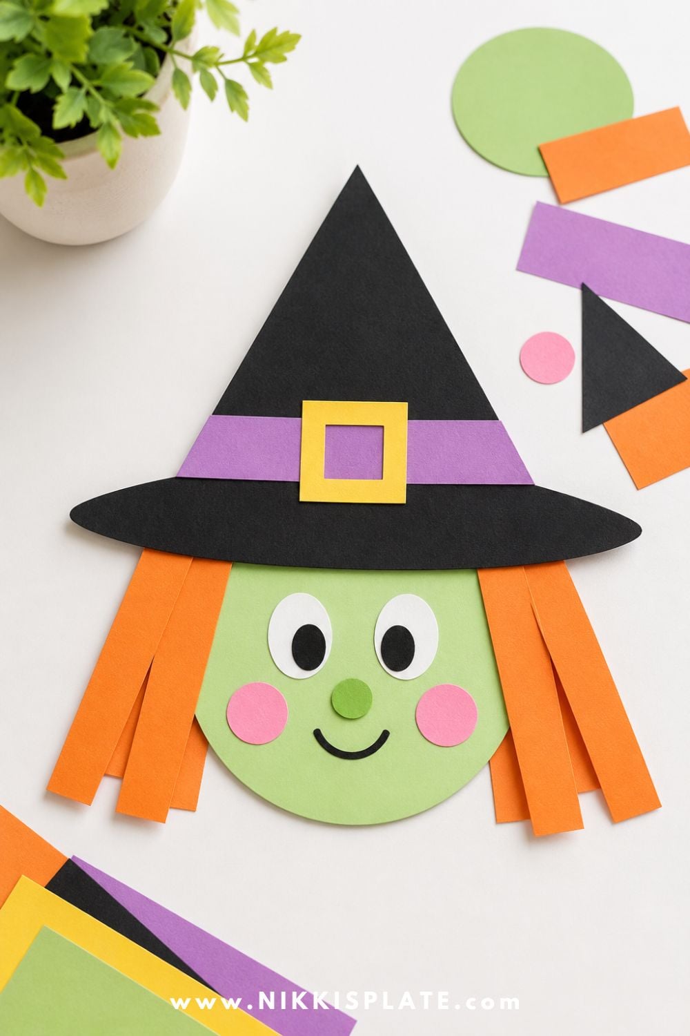 Construction paper shape witch craft with circle face, triangle hat, rectangle hair, and oval eyes for a preschool Halloween craft activity.