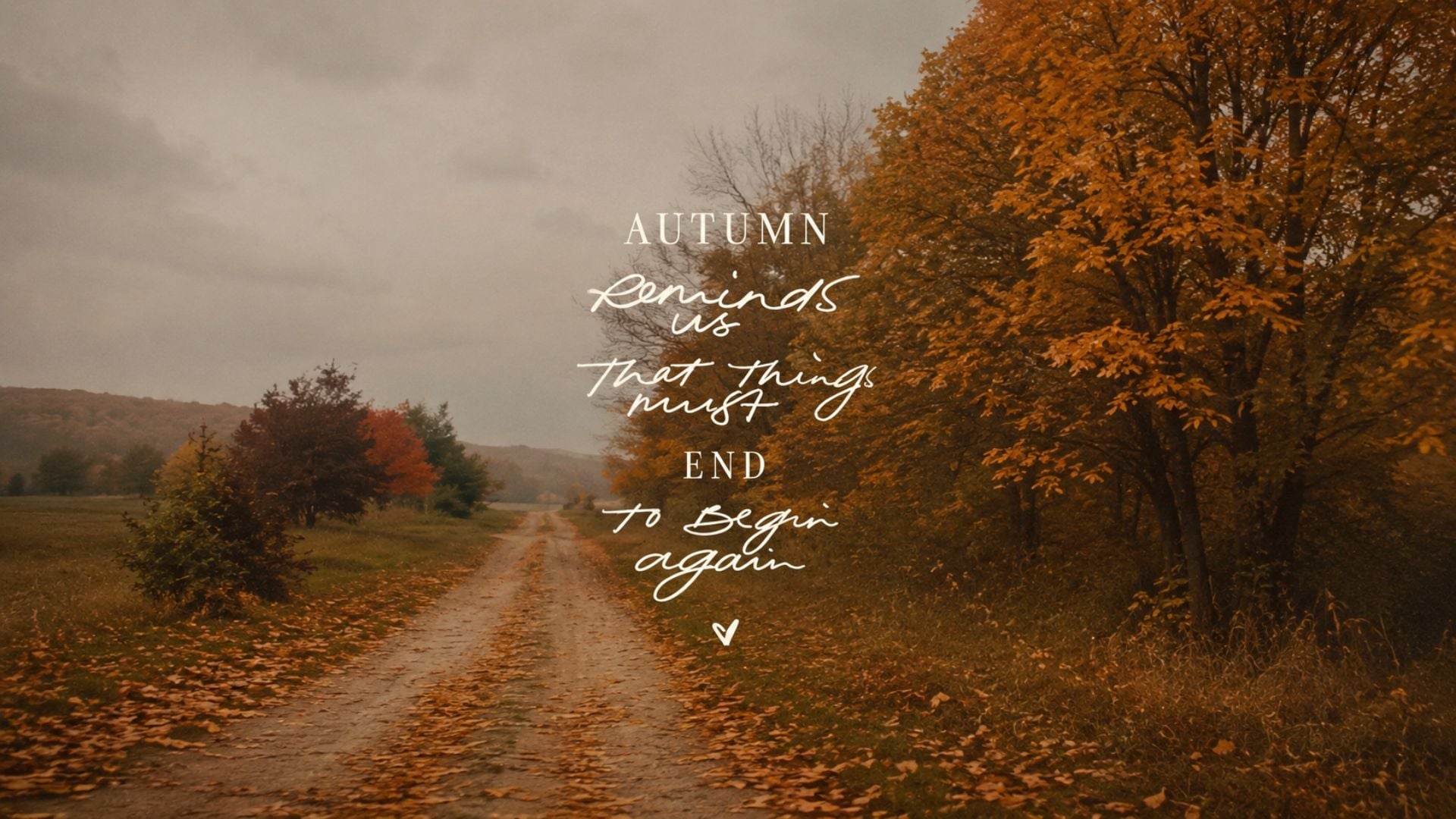 Fall desktop wallpaper aesthetic featuring a leaf-covered country lane and the quote,