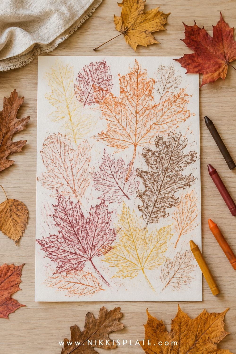 Easy fall leaf rubbings for kids showing layered maple and oak leaf patterns made with warm autumn crayons.