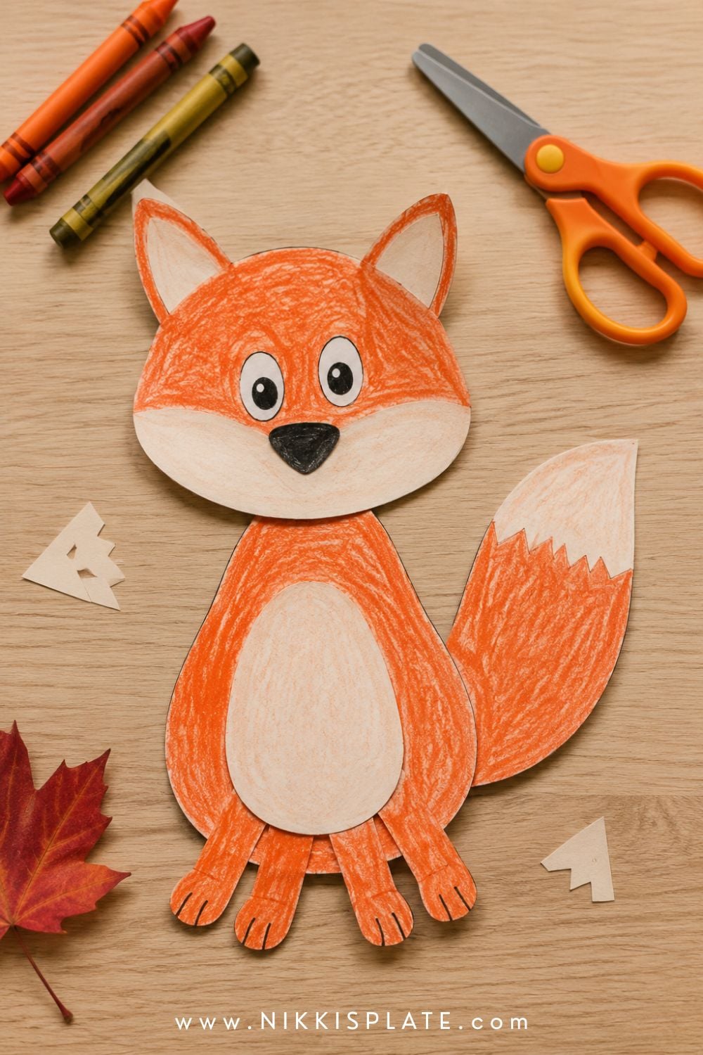 Finished printable fox craft coloured with orange crayon and assembled from layered paper pieces.