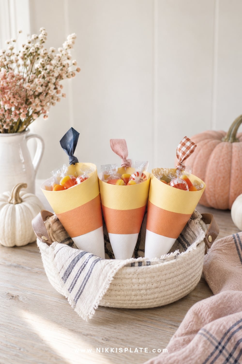 Paper candy corn cone treat bags in white, orange and yellow.