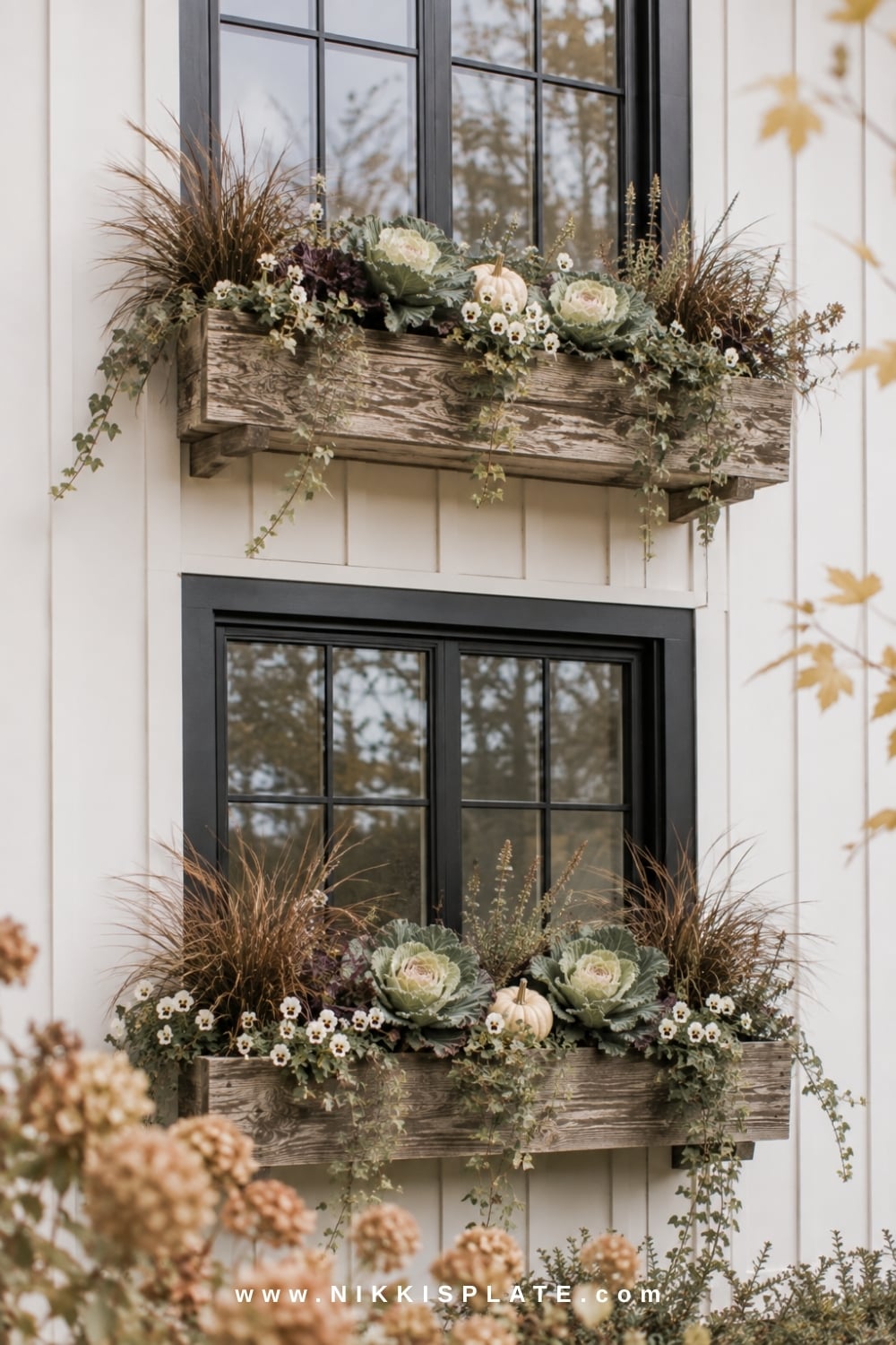 Cedar farmhouse window boxes filled with ornamental cabbage, ivy, grasses, pansies and mini pumpkins.