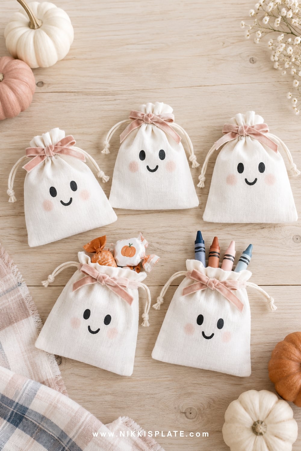 White cotton ghost pouches with black faces and blush bows.