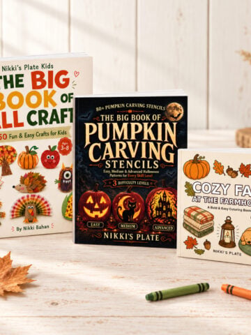 The Big Book of Fall Crafts, The Big Book of Pumpkin Carving Stencils, and Cozy Fall at the Farmhouse displayed together on a light farmhouse table.